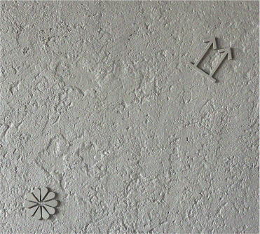 Plaster wall texture with embossed symbols at Optimist Bali